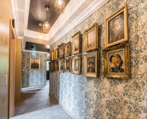 a hallway with paintings on the wall at Engel Hotel Grill Bar in Niedernhausen