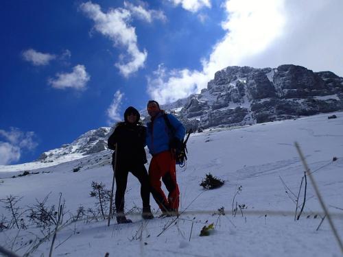 a man and woman standing on a snow covered mountain at En Chora Vezitsa in Vitsa
