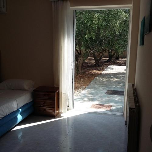 an open door to a bedroom with a bed and an open doorway at Villa Leonidas in Mastichari