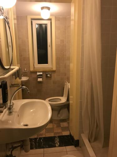 a bathroom with a white toilet and a sink at Studio's Parklake in Scheveningen