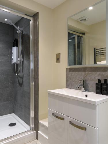 a bathroom with a sink and a shower at 5b North Parade Avenue in Oxford