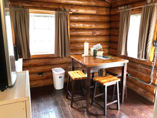 a dining room with a table in a log cabin at Gwin's Lodge & Roadhouse in Cooper Landing