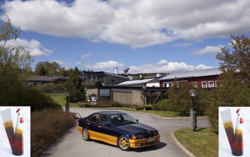 a black and orange car parked in a parking lot at STF Hotel & Hostel Persåsen in Persåsen