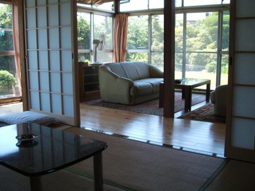 a living room with a couch and a table at YOKOSO Ryokan in Beppu