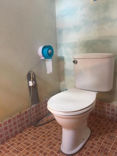 a bathroom with a white toilet in a room at Andaman Bay Bungalow in Ko Lanta