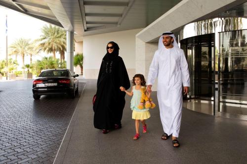 
a man and a woman standing next to each other at Hyatt Regency Dubai - Corniche in Dubai
