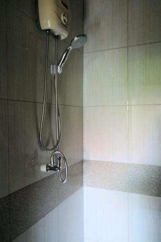 a shower with a shower head in a bathroom at Thai House Beach Resort in Ko Lanta