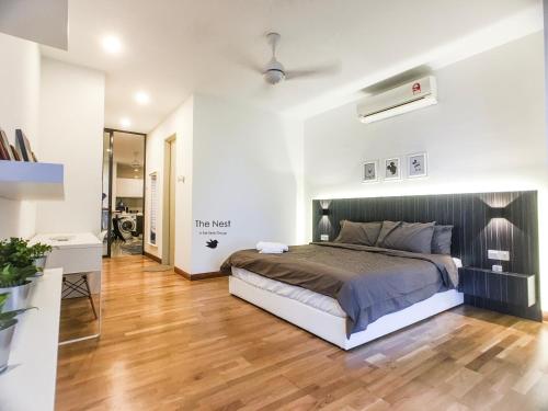 a bedroom with a large bed and a wooden floor at KL Gateway Residency in Kuala Lumpur