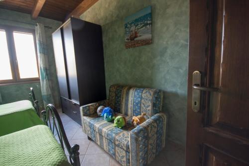 a room with a couch with two stuffed animals on it at Casa Vacanza il Mandorlo in Domusnovas