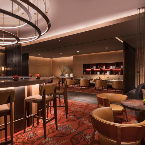 a hotel lobby with a bar and tables and chairs at Grand Hyatt Changsha-Close to Helong Sports Center in Changsha