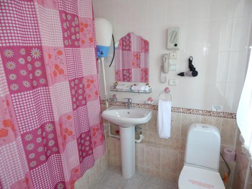 a bathroom with a sink and a toilet at Гостиница ИЛЕК in Aktobe