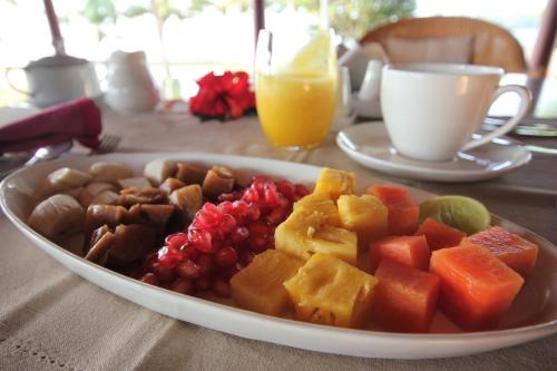 a plate of fruit and vegetables on a table at Vismaya by Moksha Stays in Turavūr