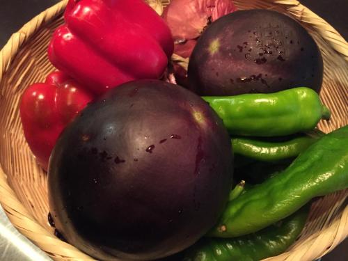 a basket filled with vegetables on a table at Gallery Nozawa Inn in Kyoto