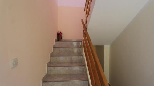 a staircase in a house with a red vase on it at Apartman Matko in Gabonjin