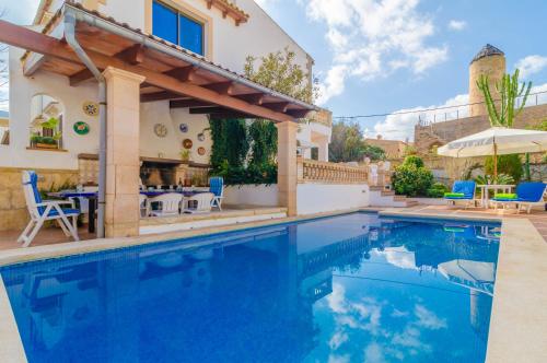 a swimming pool in a villa with a house at Can Nicolau in Colonia de Sant Pere