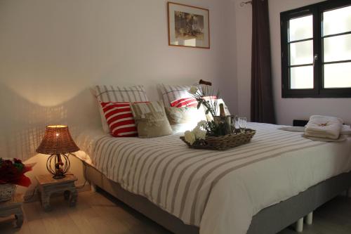 a bedroom with a bed with a basket of flowers on it at Le Clos du Square - climatisé in Rochefort