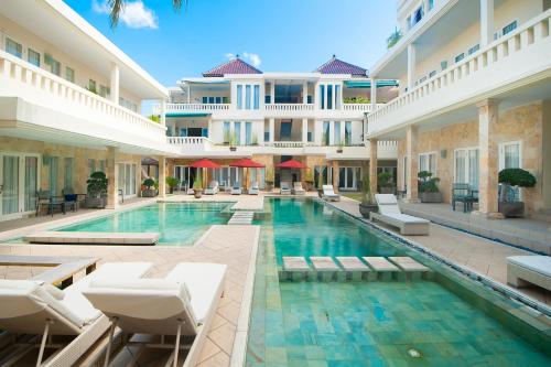 a swimming pool in the middle of a building at Bali Court Hotel & Apartment in Legian