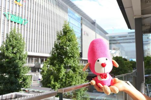 a person holding a stuffed animal in front of a building at Hotel Hokke Club Fukuoka in Fukuoka