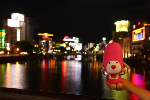 a person holding a small toy in their hand at night at Hotel Hokke Club Fukuoka in Fukuoka