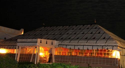 a white tent with lights on it at night at Aftas Trip in Mirleft