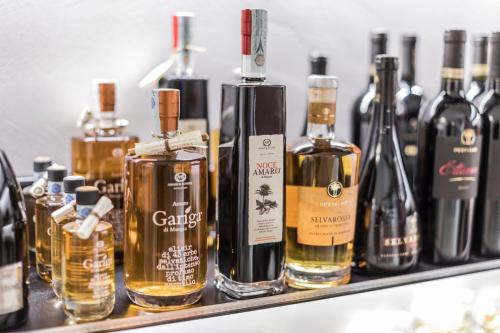 a group of bottles of alcohol sitting on a shelf at BORGOBELTRANI in Trani