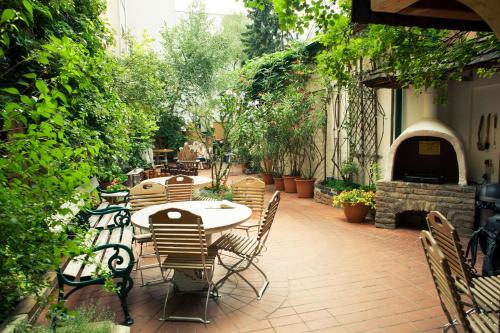 
a patio area with a table, chairs, and a patio table at Vienna Hostel Ruthensteiner in Vienna
