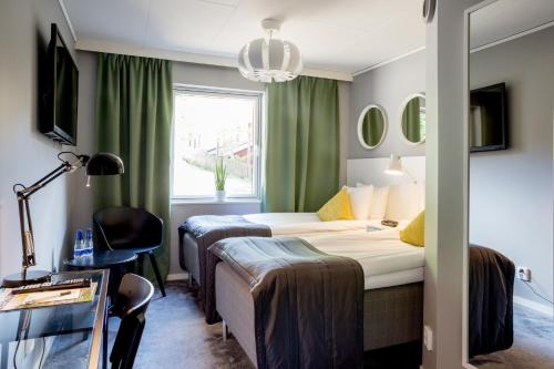 a hotel room with two beds and a window at Welcome Hotel Barkarby in Järfälla