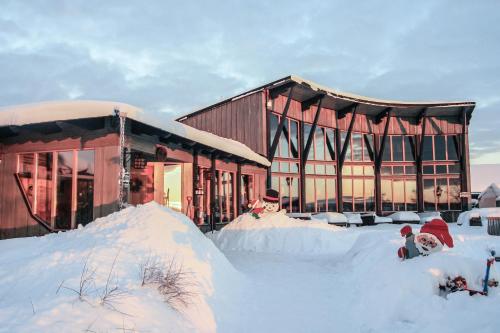 a building with a pile of snow in front of it at STF Hotel & Hostel Persåsen in Persåsen
