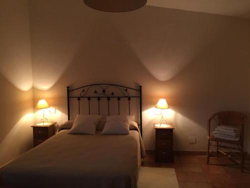 a bedroom with a bed with two lamps on it at Los Abetos in Abay