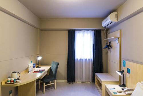 a hospital room with a desk and a window at JinJiang Inn Qinhuangdao Yanshan Univeristy in Qinhuangdao