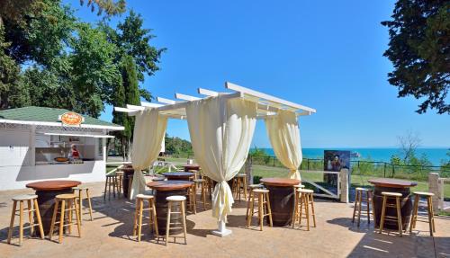 a group of tables and stools in front of a bar at Sol Nessebar Mare All Inclusive in Nesebar
