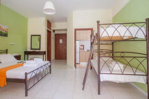 a bedroom with two bunk beds and a bathroom at Ionio Sea Poros Studios in Mikros Gialos