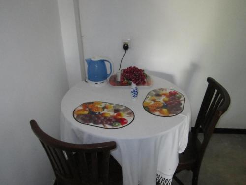 a table with two plates of fruit on it at Arazo villa in Unawatuna