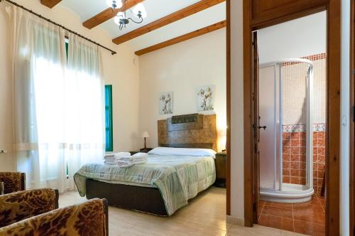 1 dormitorio con cama y ventana grande en Villamilagro, en Sueca