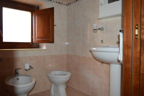 a bathroom with a toilet and a sink at La Stella Del Pollino in San Lorenzo Bellizzi