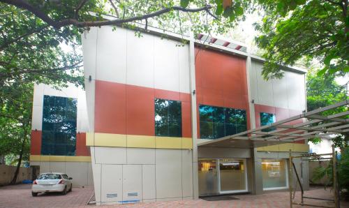 a multicolored building with a car parked in front at Treebo Trend Amber International in Mumbai
