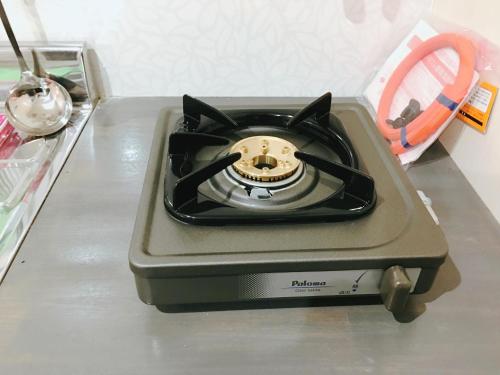 a stove sitting on top of a table at Guest House Fukuoka W001 in Kasuga