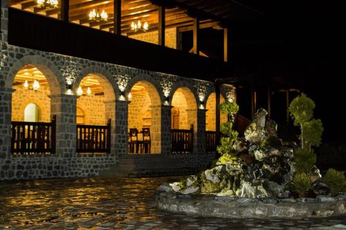 a fountain in front of a building at night at The House of the Miyaks in Rostuša
