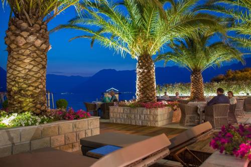 a resort with palm trees and a view of the ocean at Hotel Forza Terra in Kotor
