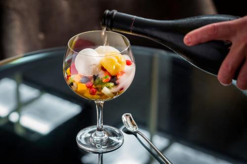 a wine glass being filled with candy inside at Sofitel Frankfurt Opera in Frankfurt/Main