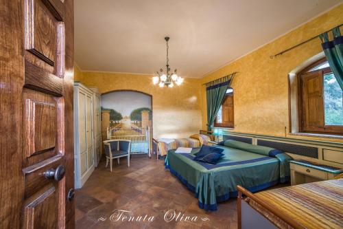 a bedroom with a bed and a dining room at Tenuta Oliva in Fisciano
