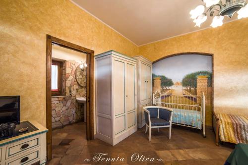 a bedroom with a bed and a painting on the wall at Tenuta Oliva in Fisciano