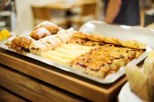 a tray of pastries and breads on a table at Hotel Schwaiger in Prague