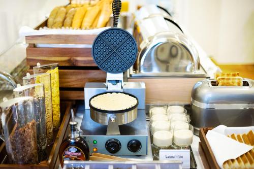 a food mixer sitting on a counter with food at Hotel Schwaiger in Prague