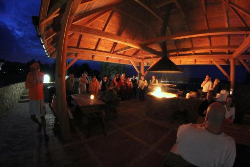 a group of people standing around a bar at night at Apartamenty Pod Łysicą & SPA - przy stoku, basen, jacuzzi, sauna in Krajno Pierwsze
