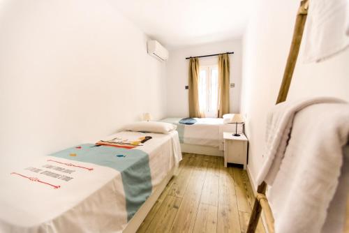 ein kleines Zimmer mit 2 Betten und einem Fenster in der Unterkunft Apartment in the centre (Judería) in Sevilla