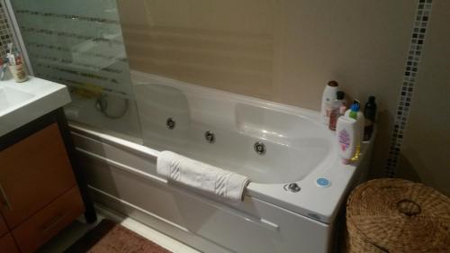 a bathroom with a bath tub with a sink at Apartamento do Atlantico in Gala