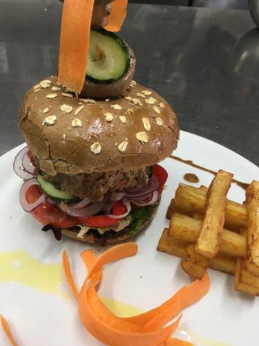 a sandwich and french fries on a white plate at Agroturismo Es Quatre Cantons in Binissalem