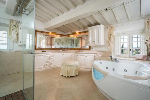 a large bathroom with a tub and a shower at Villa La Fornace in Tavarnelle in Val di Pesa