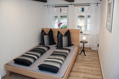a bed with pillows on it in a room at Köpi Appartements in Goslar